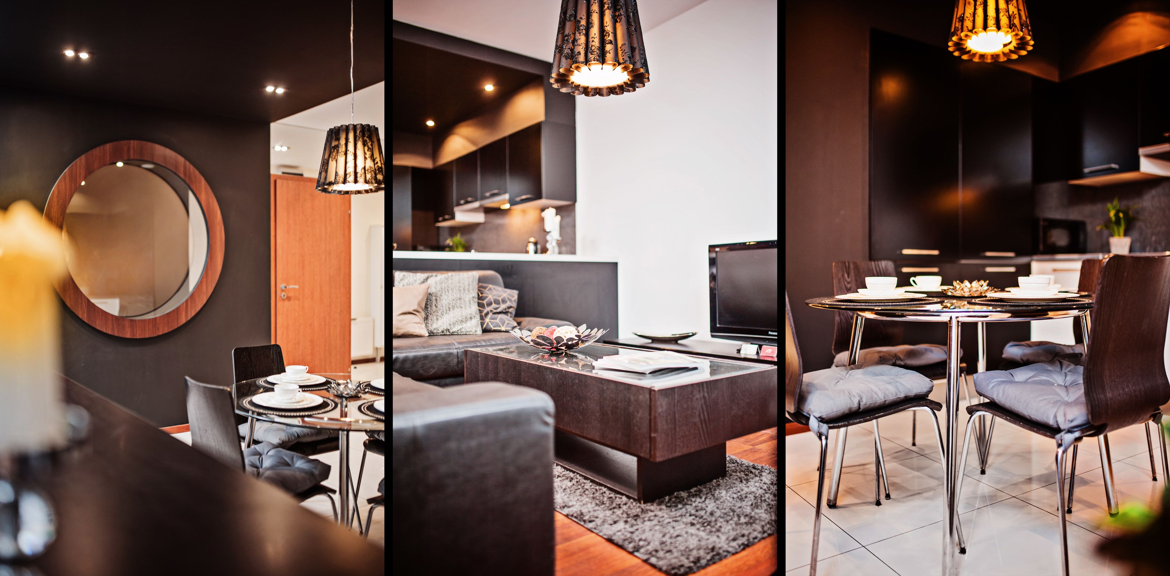 A modern living space with a round mirror, dark-toned furniture, and a dining area with a glass table and metal chairs.