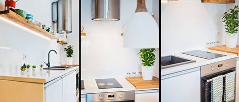 A modern kitchen with a built-in oven, a stovetop, and a sink.