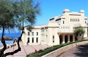 A building with a 'CASINO' sign, featuring a classical architectural style with columns and a symmetrical facade.