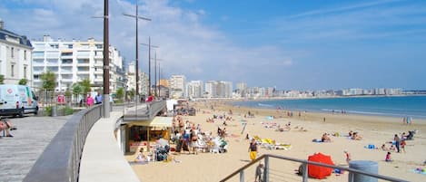 A beachside promenade with a view of the beach and ocean.