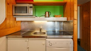 A compact kitchen with a microwave, kettle, and dishwasher. - Ski-in studio, 5 pax, pets allowed, Arc 1800 (Les Arcs 1800)