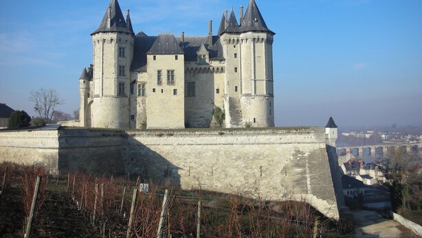 A historic castle with multiple towers and a fortified wall.