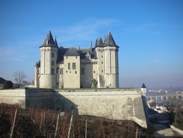 A historic castle with multiple towers and a fortified wall.
