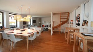 A modern interior with a dining area, a staircase, and a living space. - bloch duplex 165m2 city center 4br3bth (Colmar)