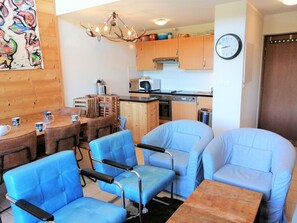 Cozy living space with a dining area, kitchen, and comfortable seating.