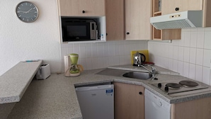A compact kitchen with a microwave, a coffee maker, a sink, and a dishwasher. - Ski-in/Ski-out Apartment for 6 with Balcony, South-Facing, 1 Bedroom, La Mongie (La Mongie)