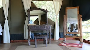 A rustic wooden vanity with a mirror, a small table, and a bench. - Ngorongoro Wild Camps (Ngorongoro)