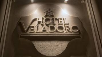 A hotel sign with the name "HOTEL VELADORO" in a bold, serif font.