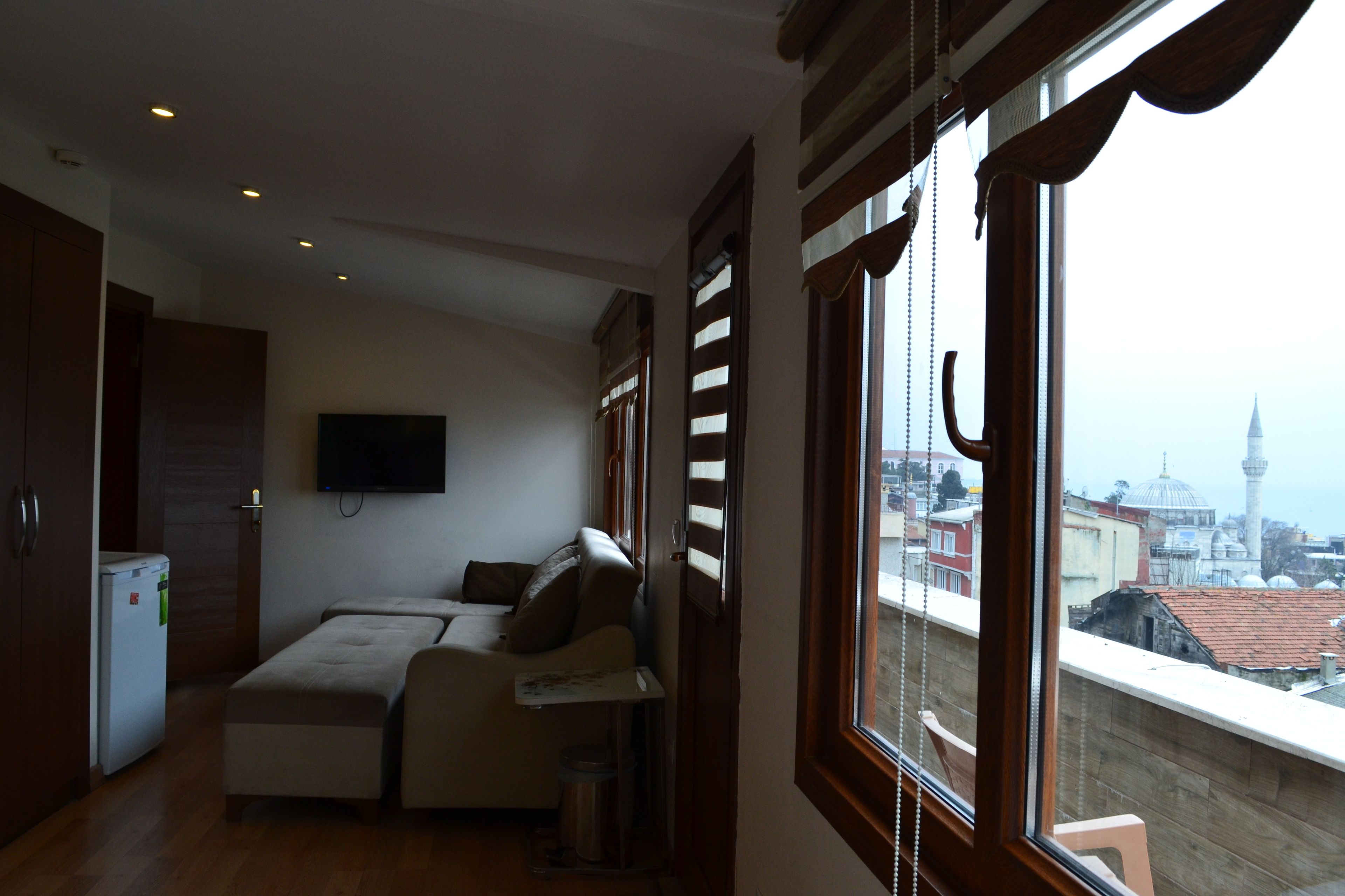 Deluxe Triple Room, Sea View | Minibar, in-room safe, desk, blackout drapes