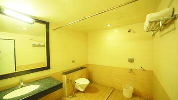 A bathroom with a sink, toilet, and shower.
