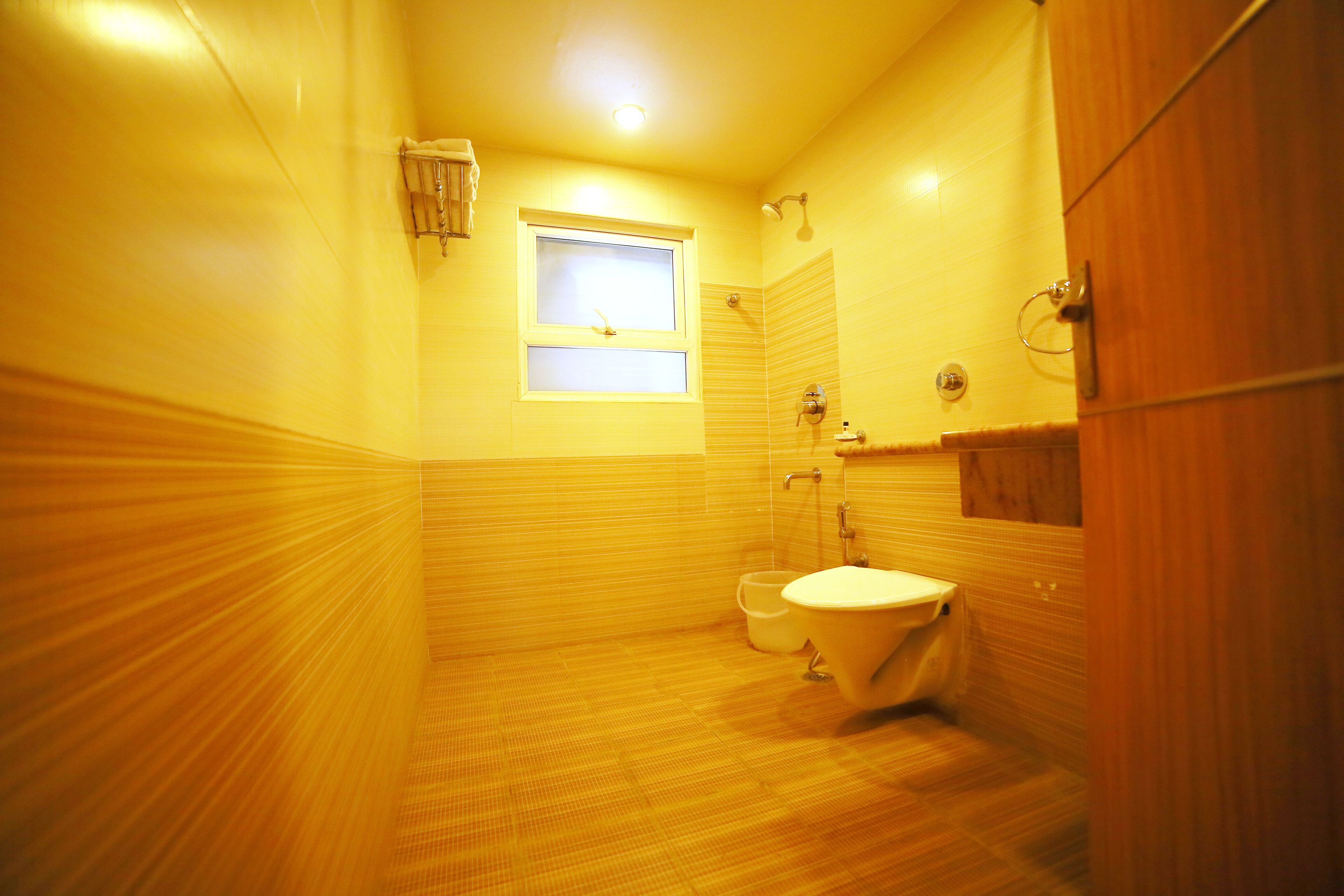 A small bathroom with a toilet, a sink, and a shower.