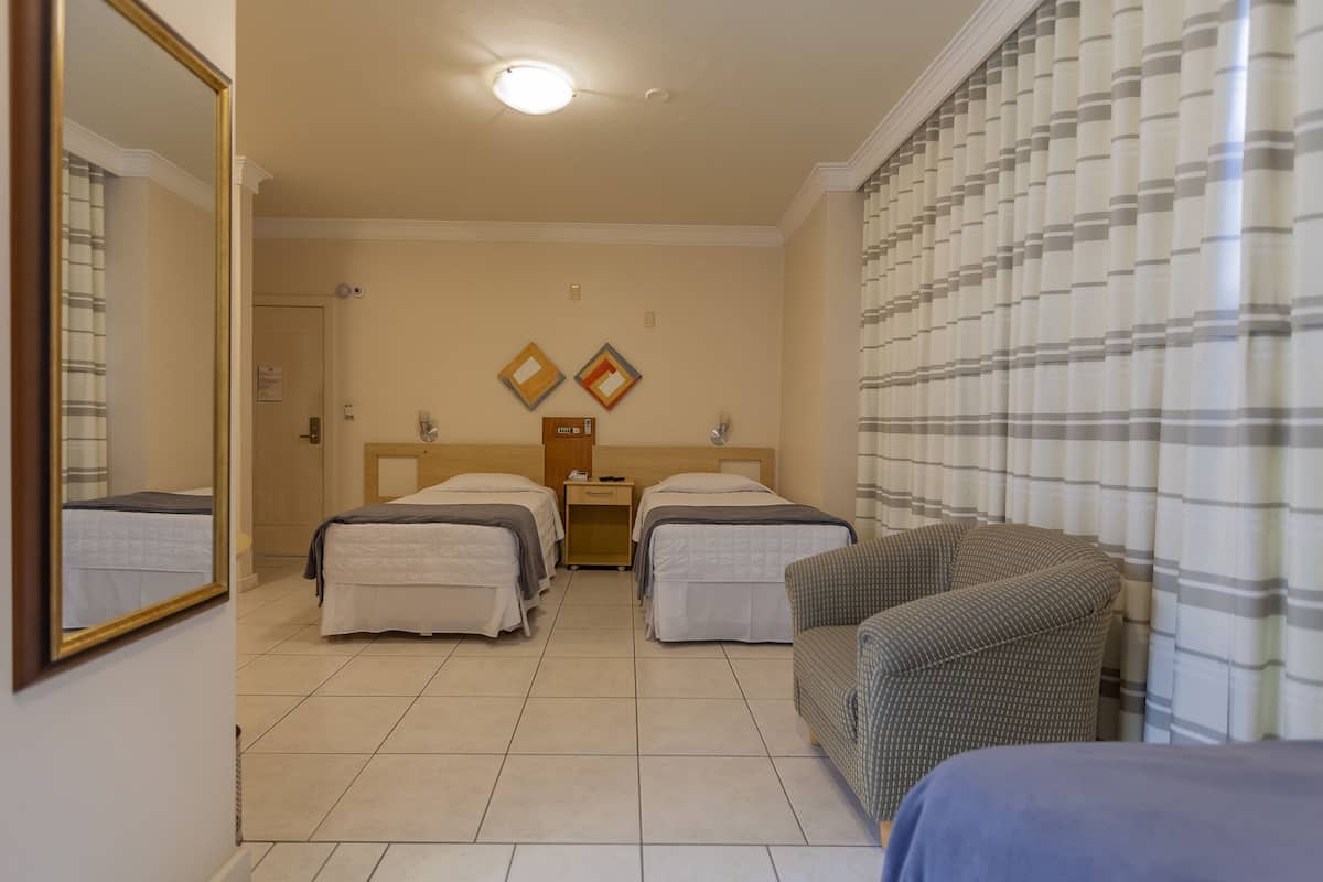 Deluxe Triple Room | Minibar, in-room safe, desk, blackout drapes