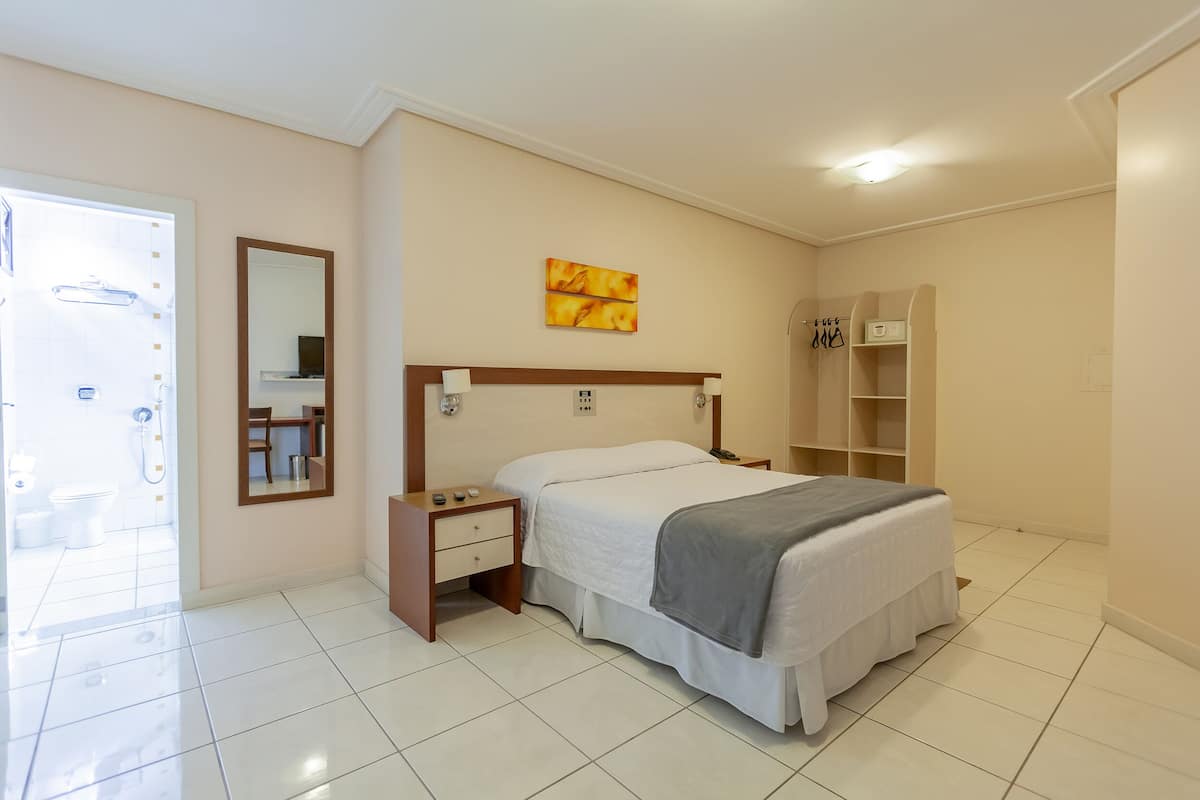 Deluxe Double Room | Minibar, in-room safe, desk, blackout drapes