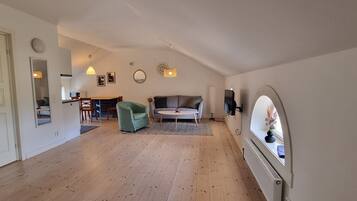 Apartment, 2 Twin Beds | Living area | Flat-screen TV, heated floors