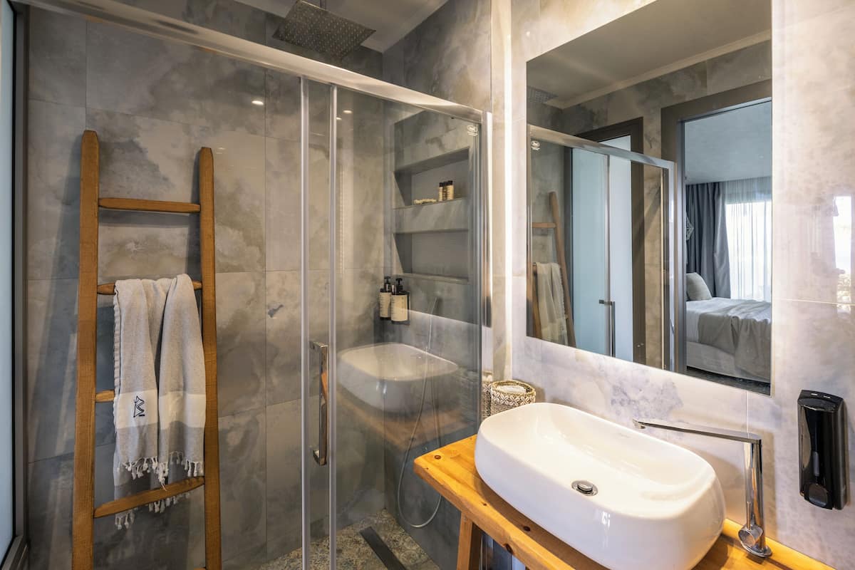 shower, hair dryer, slippers, towels