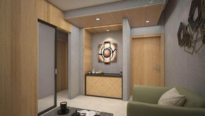 A modern interior with a wooden reception desk, a green sofa, and a wall-mounted artwork. - Hotel D Grand (Bareilly)