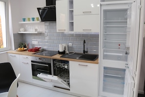 Enjoy cooking in this well-equipped kitchen with oven, dishwasher, and microwave.