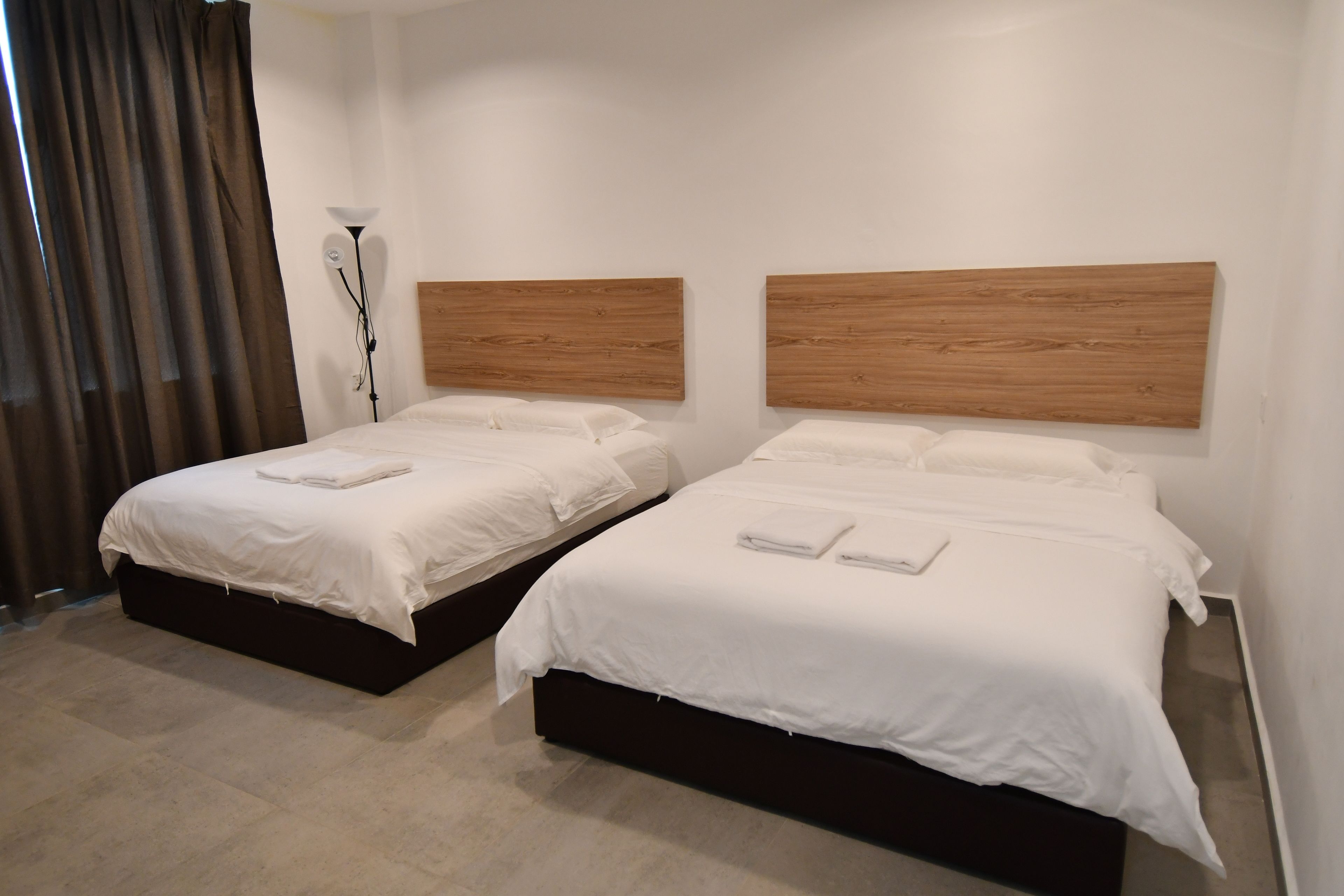 deluxe quadruple room, 2 queen beds | premium bedding, desk, iron/ironing board, free wifi