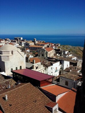 A coastal town with historic buildings and a prominent dome structure. - B&B Michael (Monte Sant'Angelo)