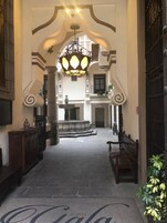 Een hotel lobby met een grote kroonluchter, een fontein en een bank.