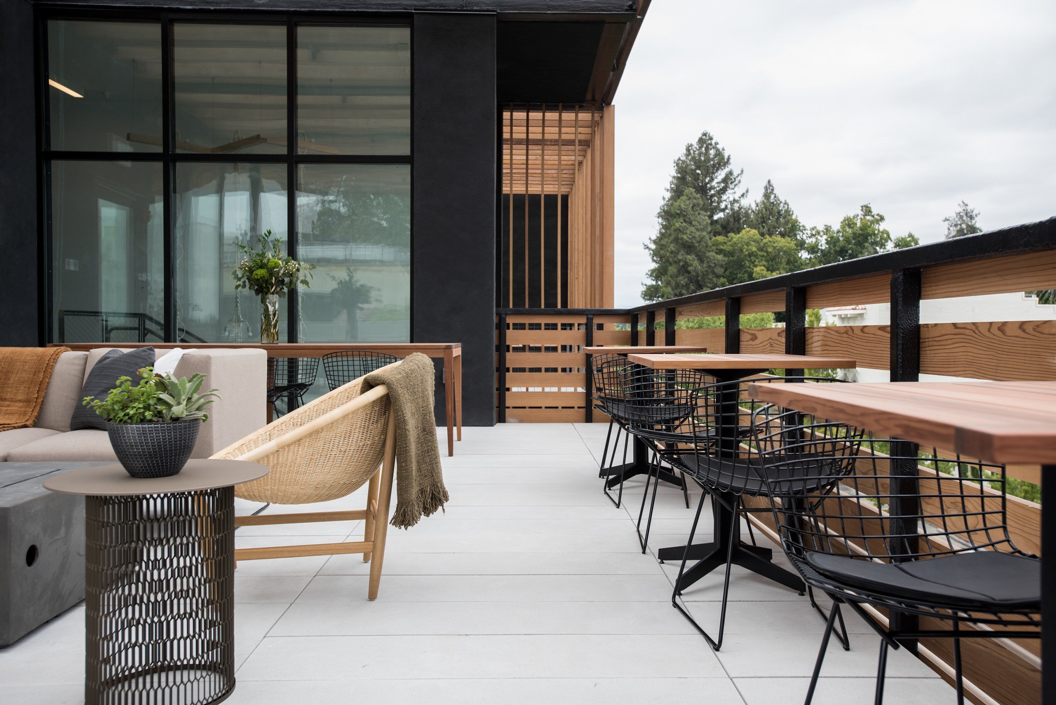 An outdoor patio with a sofa, a round table, and chairs.