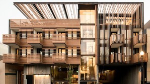 A modern building with multiple balconies and a staircase leading to an upper level. - Harmon Guest House (Healdsburg)