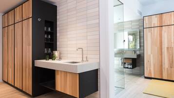 A modern kitchen with wooden cabinets, a built-in sink, and a glass backsplash.