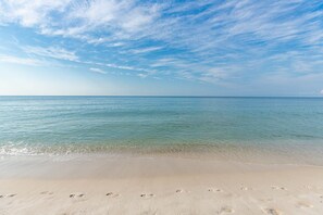 A beach with footprints in the sand and a clear sky. - One Bedroom…7th Floor of Phoenix II…Gulf Front Balcony (Orange Beach)