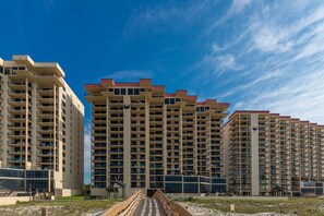 A high-rise hotel with multiple balconies and a central atrium. - One Bedroom…7th Floor of Phoenix II…Gulf Front Balcony (Orange Beach)