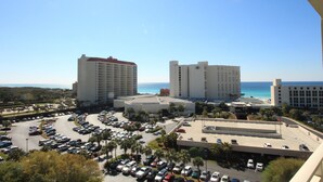 A hotel complex with multiple buildings, a parking lot, and a view of the beach. - Remodeled.  Luau 6705 in Sandestin.Tram, wifi, larger Studio with balcony (Miramar Beach)