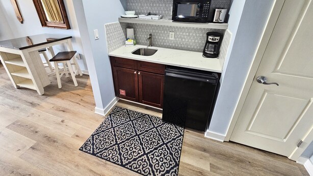 A compact kitchen with a microwave, coffee maker, and a sink. - Remodeled.  Luau 6705 in Sandestin.Tram, wifi, larger Studio with balcony (Miramar Beach)