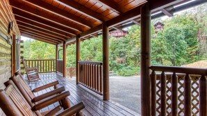 A wooden deck with benches, a railing, and a view of a forested area. - ERN807 - Black Bearry Ridge - Great Location! Close To All The Action! (Pigeon Forge)