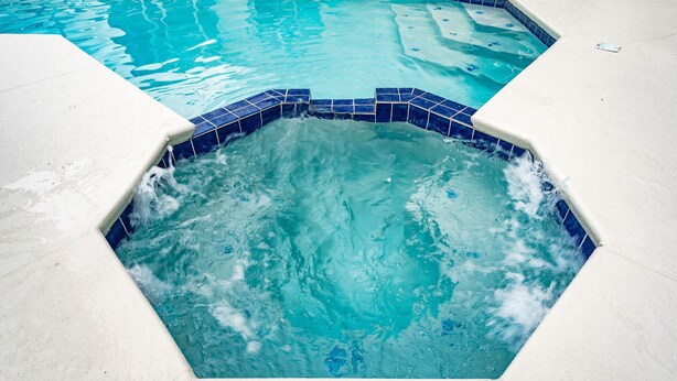 A swimming pool with a hexagonal hot tub area. - Budget Friendly! Lake View Home with a Private pool nearby to Disney (Davenport)