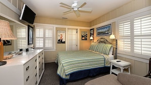 A bedroom with a bed, a desk, a chair, a television, and a ceiling fan. - 359CA: Charming Family Home, 3 Blocks to Beach, Restaurants and Shops (Avalon)