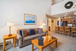 Relax in this inviting living space with a sofa, dining table, and kitchen area.