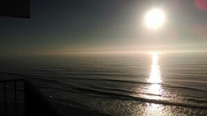 A sunset over a calm sea with a clear horizon.