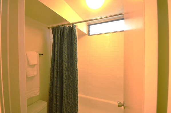 A bathroom with a toilet, a shower curtain, and a bathtub. - Kuhio Village 810A KING Studio, Waikiki Ocean View! (Honolulu)