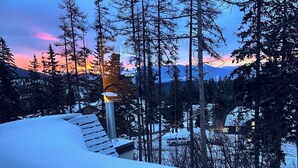 A snowy landscape with a clear view of a mountain range and a sunset. - 2 story 3 bedroom Ski condo on Hailey’s run at Whitefish Mountain Resort.  (Whitefish)
