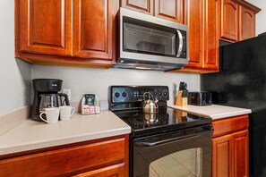 Homely Kitchen Comfort: Embrace the warmth of our inviting kitchen, where home-cooked meals become cherished moments - Premium 3BR condo Resort Perks near Epic Universe (Orlando)