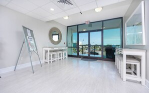 Enjoy a spacious room with a large mirror, functional workspace, and a glass door leading to an outdoor area.