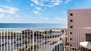 A balcony with a view of the ocean and a parking lot. - 🌊 Islander #609 – Coastal Elegance with Stunning Gulf Views! 🏖️✨ (Destin)