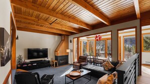 A spacious living room with a fireplace, a large TV, and comfortable seating. - Keystone Townhome Close to Shuttle for Lifts & Short Walk to Lakeside Village (Keystone)
