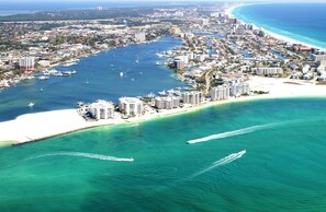 An aerial view of a coastal city with a marina, beachfront hotels, and a clear blue sea. - Blue Surf 12B- Beautiful 2bd unit w/gulf views (Miramar Beach)
