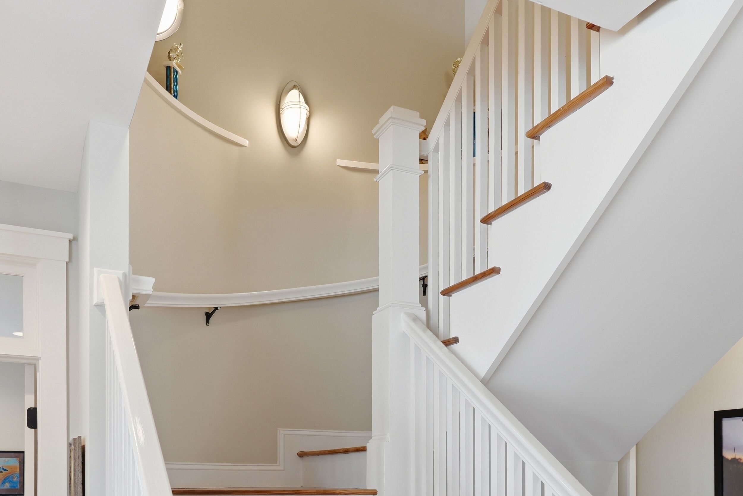 A staircase with white railings and wooden steps.