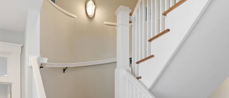 A staircase with white railings and wooden steps.