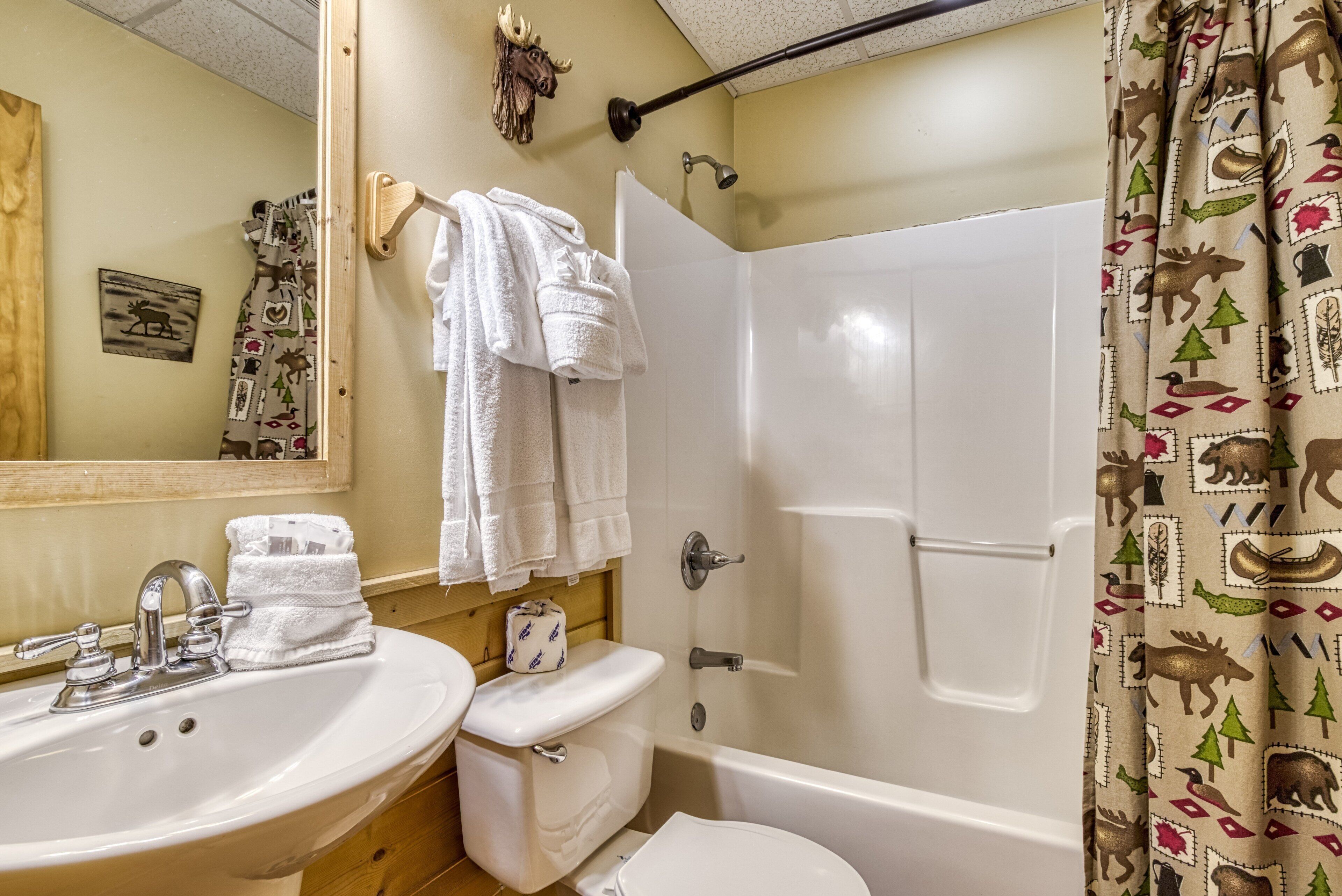 A bathroom with a sink, toilet, and bathtub.