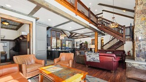 A spacious living area with leather furniture, a wooden coffee table, and a stone fireplace. - Great for Big Groups, Mile from Lifts, High End Finishes, Huge Deck, Hot Tub (Keystone)