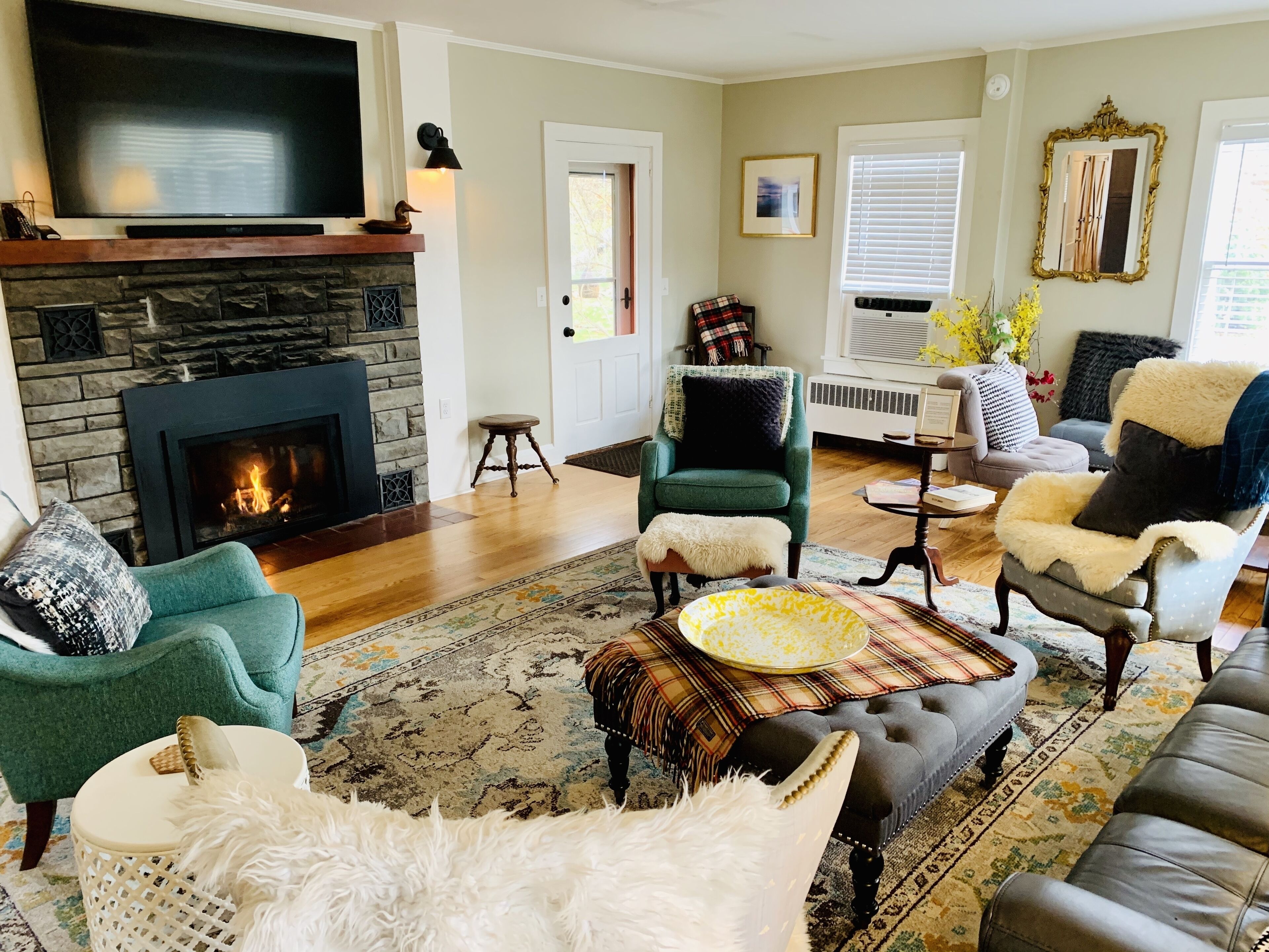 A living room with a fireplace, comfortable seating, and a television.