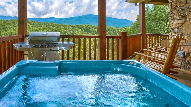 A hot tub on a wooden deck with a mountain view. - Knockin On Heavens Door: Incredible Views, Theater (Gatlinburg)