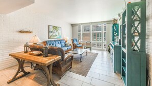 A spacious living area with a sofa, chairs, a coffee table, and a dining table. - This fabulous upscale condo, complete with elevator access, sits right on the sh (Port Aransas)